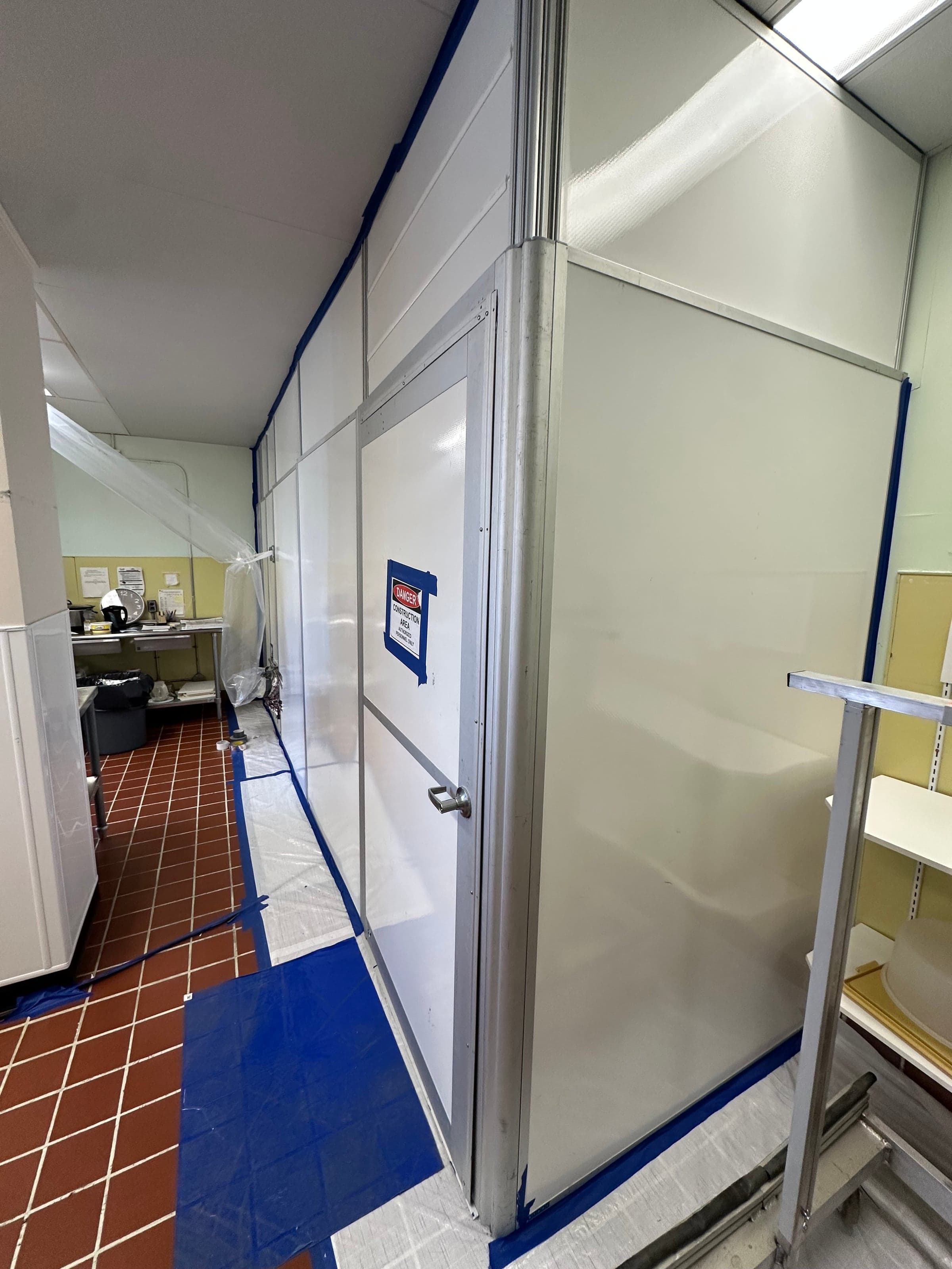 Interior construction hoarding by Aztec Group — sealed work zone